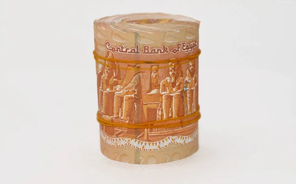 Egypt money bundle roll of pounds, 1 EGP LE one Egyptian pound cash money bills rolled up with rubber bands with a image of Mosque and mausoleum of Qaitbay and Abu Simbel temples isolated on white