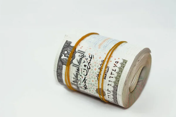 20 EGP LE twenty Egyptian pounds cash money bills rolled up with rubber bands with a image of Muhammad Ali mosque, Pharaonic war chariot, frieze from chapel of Senusret I, Egypt money bundle roll