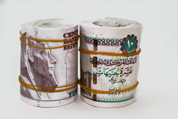 stock image 10 EGP LE ten Egyptian pounds cash money bills rolled up with rubber bands with a image of Al Rifa'i the royal mosque and khafre enthroned, Egypt money bundle roll, selective focus