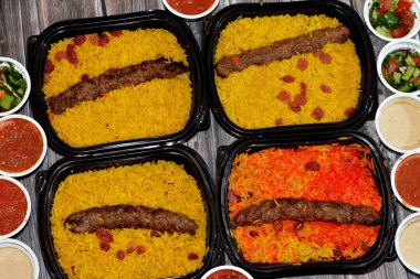 Arabic cuisine traditional food beef  Kofta, kebab and tarb kofta shish which is minced meat with Basmati rice and raisins, oriental grilled barbecued meat food with long yellow rice, selective focus