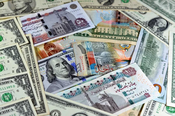 Egyptian pounds currency with American USA dollars cash money banknotes of different values and Kuwait dinars bills, Kuwaiti money, Egyptian pound EGP LE and American currency exchange rate concept