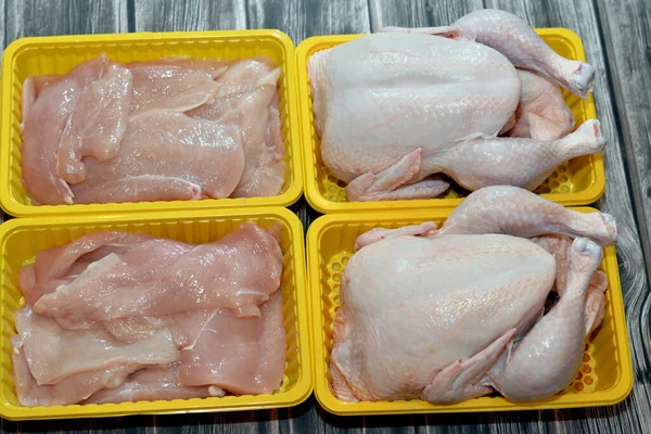 Raw fresh chicken with skin and bones, the whole chicken with breasts, legs, thighs, chicken meat that is ready for baking, grilling, barbecuing, frying or boiling and chicken boneless fillet filets