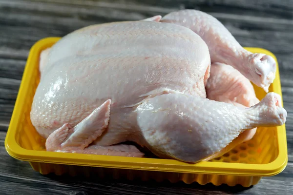 Fresh raw chicken with skin and bones, the whole chicken with breasts, legs, thighs, chicken meat that is ready for baking, grilling, barbecuing, frying or boiling, selective food of white meat