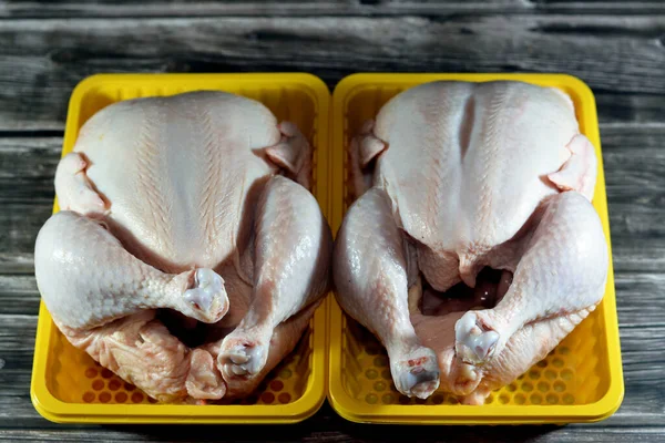 Fresh raw chicken with skin and bones, the whole chicken with breasts, legs, thighs, chicken meat that is ready for baking, grilling, barbecuing, frying or boiling, selective food of white meat