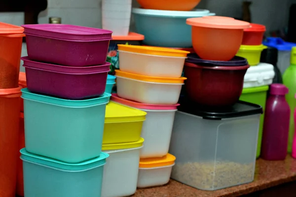 Cairo, Egypt, February 4 2021: pile of several and many Tupperware plastic products, Tupperware Corporation, an American multinational company produces plastic food storage containers and bottles