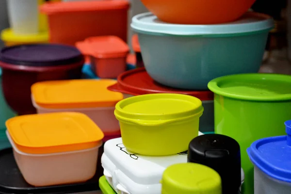 Cairo, Egypt, February 4 2021: pile of several and many Tupperware plastic products, Tupperware Corporation, an American multinational company produces plastic food storage containers and bottles