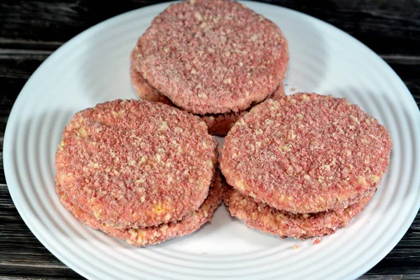 stock image spicy chicken burger with blend of rich chilly spices and ingredients and breadcrumbs, usually made of with ground chicken, seasoned bread crumbs, grated onion, and garlic ready to be fried in oil