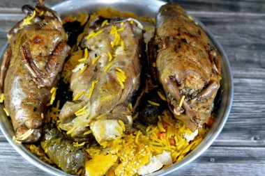 Mısırlı Hamam güvercinleri Mahshi güvercini pirinçle doldurdu ve kuzu inciği fırında pişirildi Basmati pilavı ve sebzelerle doldurulmuş üzüm yaprakları ile iyi pişirildi.