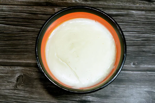粉ミルクとプレーンMehalabia Muhallebi 一般的に米 牛乳と米粉 でんぷんまたはセモリナのいずれかで作られた中東のミルクプリン木製の背景に隔離された — ストック写真