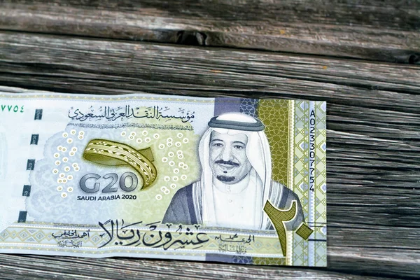 Obverse side of 20 SAR twenty Saudi Arabia Riyals banknote currency bill money Commemorative issue with portrait of king Salman , 3D logo of the Kingdom\'s Presidency of G20 summit in 2020 AD 1442 AH