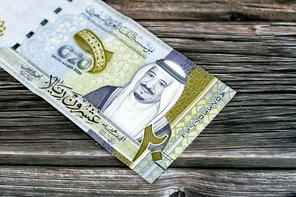 Obverse side of 20 SAR twenty Saudi Arabia Riyals banknote currency bill money Commemorative issue with portrait of king Salman , 3D logo of the Kingdom\'s Presidency of G20 summit in 2020 AD 1442 AH