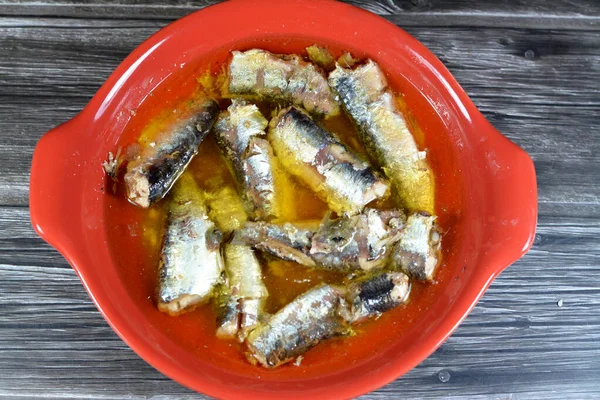 Canned spiced Sardines in vegetable oil, easy opening, sardine fish pilchards nutrient-rich, small, oily fish, a source of omega 3 fatty acid, seafood cuisine of Sardine fish with oil and lemon