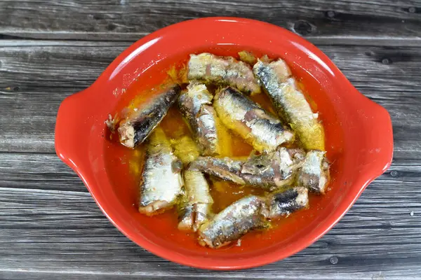 Canned spiced Sardines in vegetable oil, easy opening, sardine fish pilchards nutrient-rich, small, oily fish, a source of omega 3 fatty acid, seafood cuisine of Sardine fish with oil and lemon