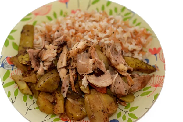 white rice with vermicelli cooked on hot steam, slices of potatoes, zucchini, onion and tomato  with chicken chunks and pieces cooked in the oven, Egyptian Arabic Chicken and vermicelli rice cuisine