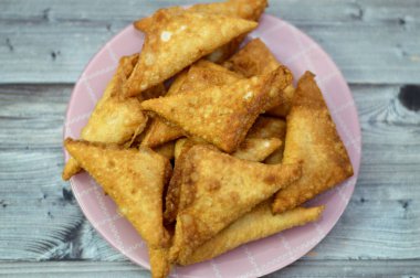 Bir samosa Singara, içinde baharatlı patates, soğan, bezelye, et ya da balık gibi malzemeler bulunan tuzlu bir Güney Asya hamur işi Sambousek genellikle Ramazan ayında Orta Doğu 'da tüketilir.