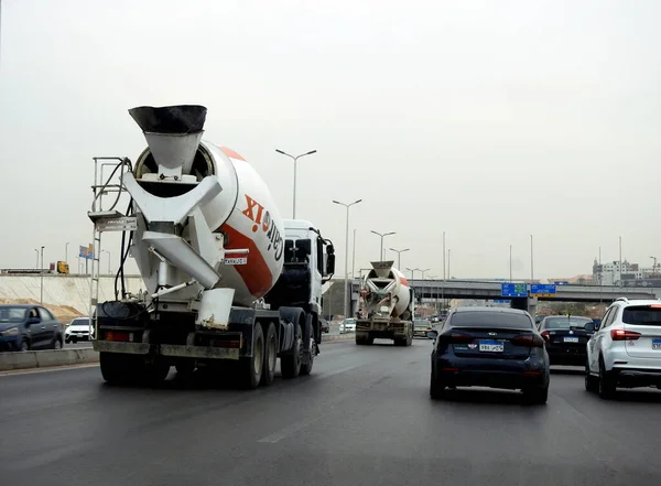 stock image Cairo, Egypt, May 16 2023: A concrete and cement transit mixer lorry truck on its way to deliver concrete to a construction site, it combines cement, aggregate such as sand or gravel, and water