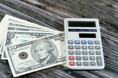 Kahire, Mısır, 31 Mayıs 2023: Casio Güneş enerjili hesap makinesi, el bilgisayarlı elektronik hesap makinesi, Amerikan para döviz kurları ve ekonomi konsepti ile Amerikan doları nakit para banknotları