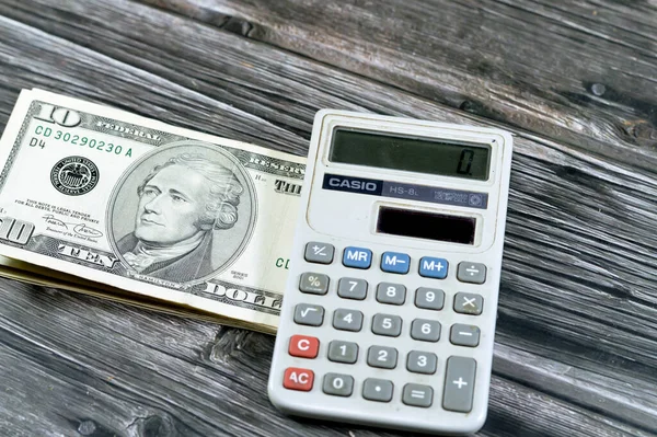 stock image Cairo, Egypt, May 31 2023: USD American dollars cash money bills currency with Casio Solar-powered calculator, hand-held electronic calculator, concept of  American money exchange rates and economy