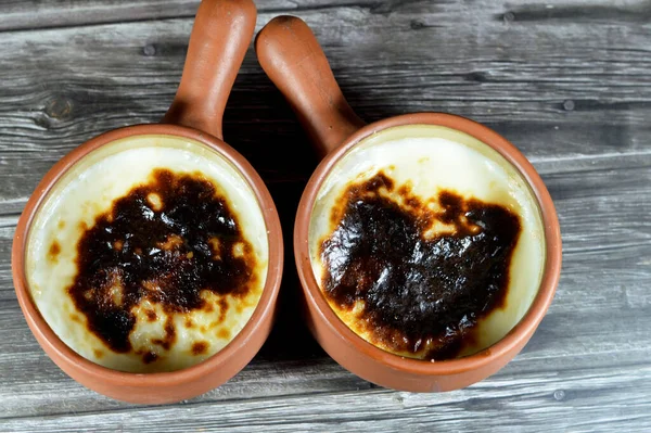 Rice pudding pottery casserole baked in the oven, rice, corn flour, sugar, water or milk and other ingredients such as cinnamon, vanilla, called Riz au lait, stla, Sholezard and moghli