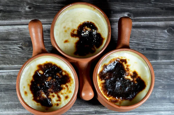 Rice pudding pottery casserole baked in the oven, rice, corn flour, sugar, water or milk and other ingredients such as cinnamon, vanilla, called Riz au lait, stla, Sholezard and moghli