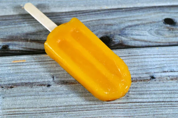 Mango Frozen ice cream stick, a creamy and delicious frozen dessert, concept of confectionary summer times, frozen snack treat of ice-cream, selective focus of fruit iced creamy treat