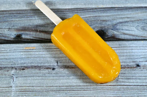 Mango Frozen ice cream stick, a creamy and delicious frozen dessert, concept of confectionary summer times, frozen snack treat of ice-cream, selective focus of fruit iced creamy treat