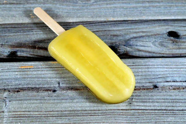 Pineapple Frozen ice cream stick, a creamy and delicious frozen dessert, concept of confectionary summer times, frozen snack treat of ice-cream, selective focus of fruit iced creamy treat