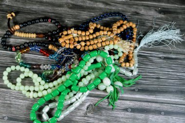 Prayer beads, a form of beadwork used to count the repetitions of prayers, A misbaha, a device used for counting tasbih zekr Islamic prayers praising Allah, has 2 forms 99 beads and 33 beads clipart
