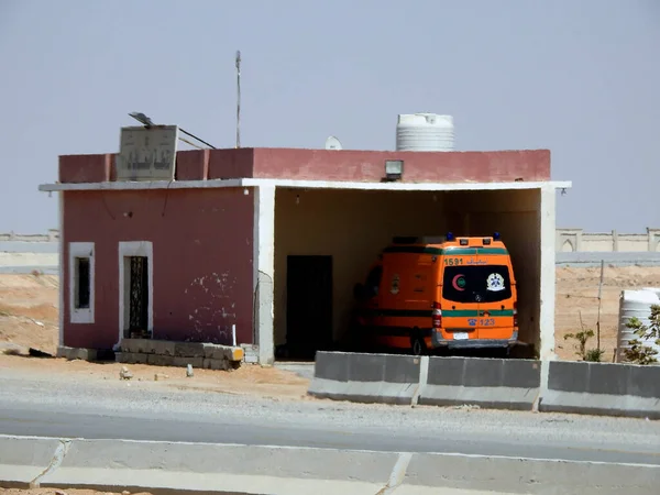 stock image Cairo, Egypt, June 30 June 2023: An  Emergency road ambulance point at the Suez Cairo desert road with an ambulance ready to respond to any emergency call for car accidents on the Suez highway