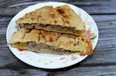 Traditional Egyptian dish Hawawshi, pita stuffed with minced meat and spiced with onions, pepper, parsely and chilies, baked by filling flat Egyptian bread with the meat mix then baking it in the oven