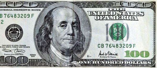 Large fragment of the obverse side of 100 one hundred dollar banknote currency series 2001 with the portrait of president Benjamin Franklin, vintage retro of old American money, Selective focus