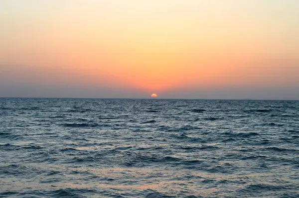 stock image Scenic sunset on the south Sinai beach, sun going down before night at the coast of the red sea in Egypt, the twilight could be seen on sky at the end of the golden color, selective focus