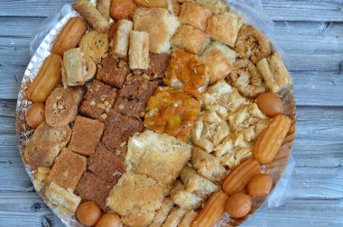 Arabic sweets cuisine, middle eastern, Syrian, Egyptian and Turkish desserts of delicious collection of Ramadan traditional desserts, basbosa, konafa, baklava, tulumba and Zalabia served with nuts clipart