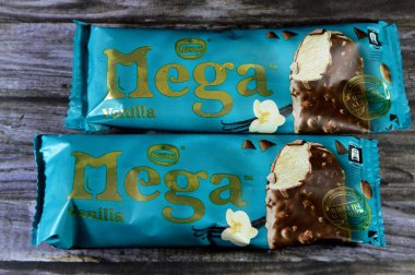 Kahire, Mısır, 15 Temmuz 2023: Nestle Mega Vanilla bademli badem dondurma çubuğu kaplanmış ve fındıklı koyu çikolata ile kaplanmış, çikolata aromalı dondurma, kızarmış badem.