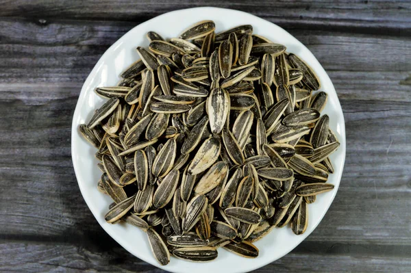 seeds of the sunflower (Helianthus annuus), Types are linoleic, high oleic and sunflower oil seeds, commonly eaten as a snack, but can also be consumed as part of a meal, eaten plain or salted