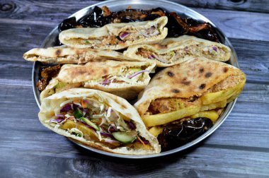 fried potatoes fingers sandwich and flat breads with mashed fava beans and traditional Egyptian dynamite sandwiches filled with fava beans, eggs,  green burger, potatoes fried fingers and aubergine