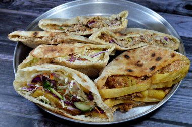 fried potatoes fingers sandwich and flat breads with mashed fava beans and traditional Egyptian dynamite sandwiches filled with fava beans, eggs,  green burger, potatoes fried fingers and aubergine