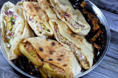 fried potatoes fingers sandwich and flat breads with mashed fava beans and traditional Egyptian dynamite sandwiches filled with fava beans, eggs,  green burger, potatoes fried fingers and aubergine