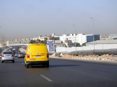 Kahire, Mısır, 31 Ağustos 2023: DHL kamyonu bir paket teslimatı yapıyor, DHL uluslararası nakliye, kurye hizmetleri ve taşımacılık alanında uzmanlaşmış lojistik sektöründe küresel lider.