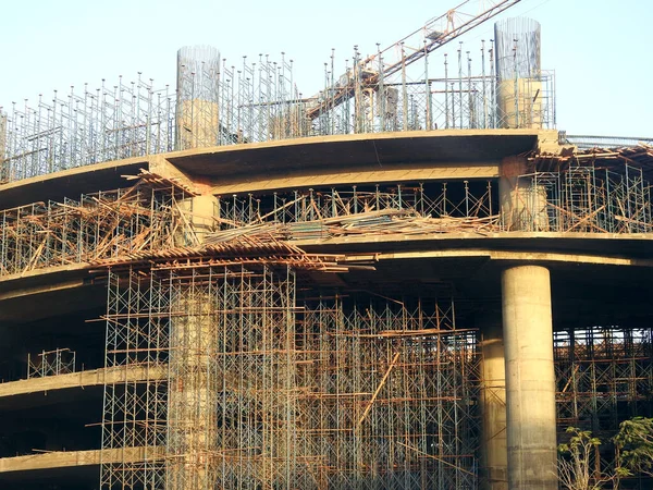 A construction site of a new building, with crane tower, metal scaffoldings, cement structures, concrete and steel columns, one of the real estate projects in Egypt, new buildings, high rise in Cairo