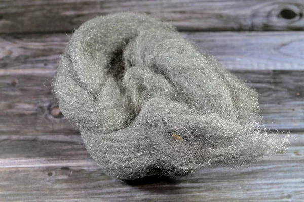 Steel wool or iron wire sponge, a bundle of very fine and flexible sharp-edged steel filaments, used as an abrasive in finishing and repair work for polishing wood or metal objects, cleaning cookware