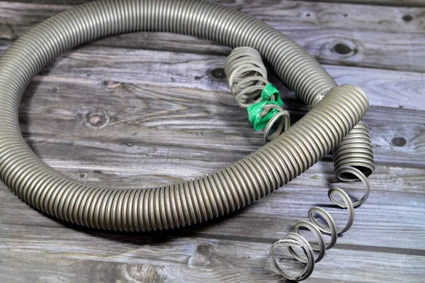 A broken flexible hose from a vacuum cleaner, substandard materials and maintenance services concept, a vacuum cleaner is an electrical house machine that collects dust and dirt by suction pressure
