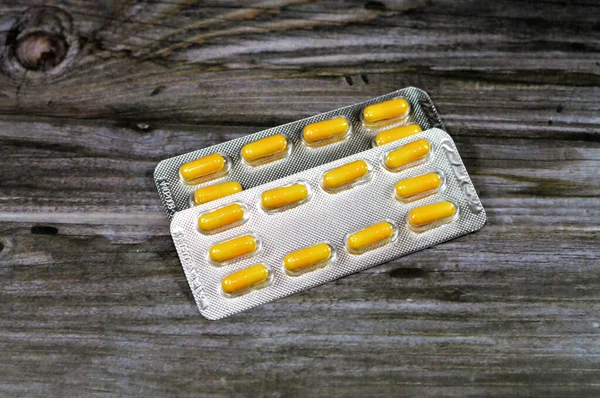 Medication capsules, yellow capsules, treatment, remedy, drug usage, abuse, prescription concept, painkillers and antibiotics, analgesics, taking a medication tablets, pill background