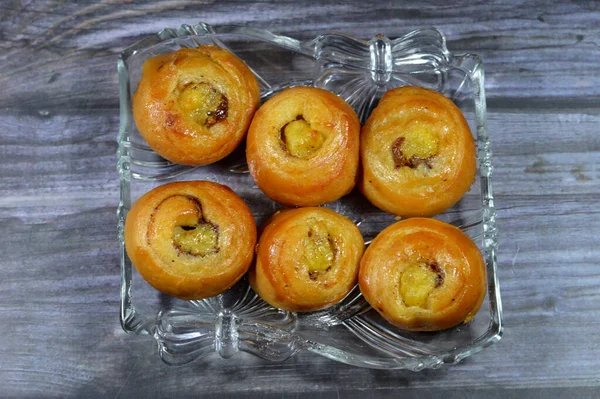 Mini Cinnamon swirl puff roll sweetened with honey and raisins and filled with custard cream baked, selective focus of pastries croissant bakery rolled Danish isolated and ready to be served