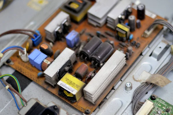 Kahire, Mısır, 26 Eylül 2023: LCD TV televizyonunun ana güç devresi, kablolar, trafolar, direniş, IC, kondansatörler, LG TV LCD 'nin elektronik devreli ana kartının onarımı