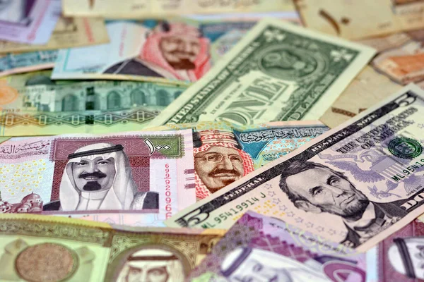 Background of Saudi Arabia riyals money banknotes bill and United States Of America dollars notes, American and Saudi money exchange rate, economy status of KSA and USA, pile of vintage retro cash