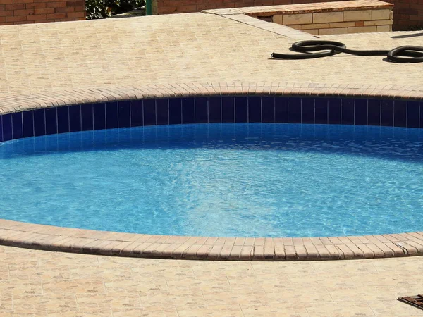 A swimming pool, swimming bath, wading paddling pool, a structure designed to hold water to enable swimming or other leisure activities, Pools can be built into the ground (in-ground pools)