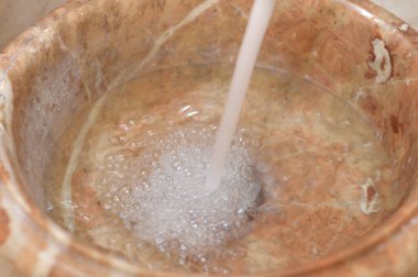 Havza musluğundan akan bol su, banyo ya da mutfaktaki su akışını kontrol etmek için kullanılan bir çeşme, sudan tasarruf, sızıntı, su kesintisi, fiksasyon, bakım konsepti