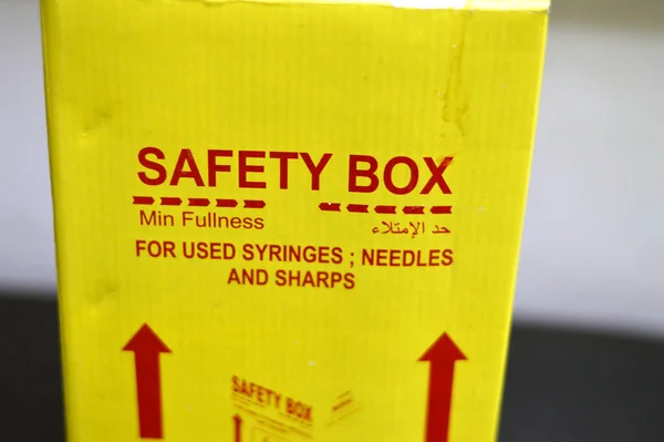 Translation of Arabic text (Fullness level), a safety box contains medical waste of sharp needles, syringes, dangerous sharp used objects, broken ampoules and other hazardous objects in side a bin