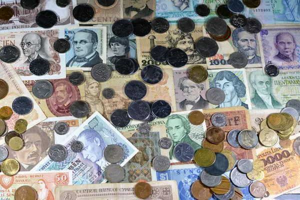 Old money currency of banknotes and coins from different countries of the world, world economy during different times concept, inflation, vintage retro old historic cash money notes and coins